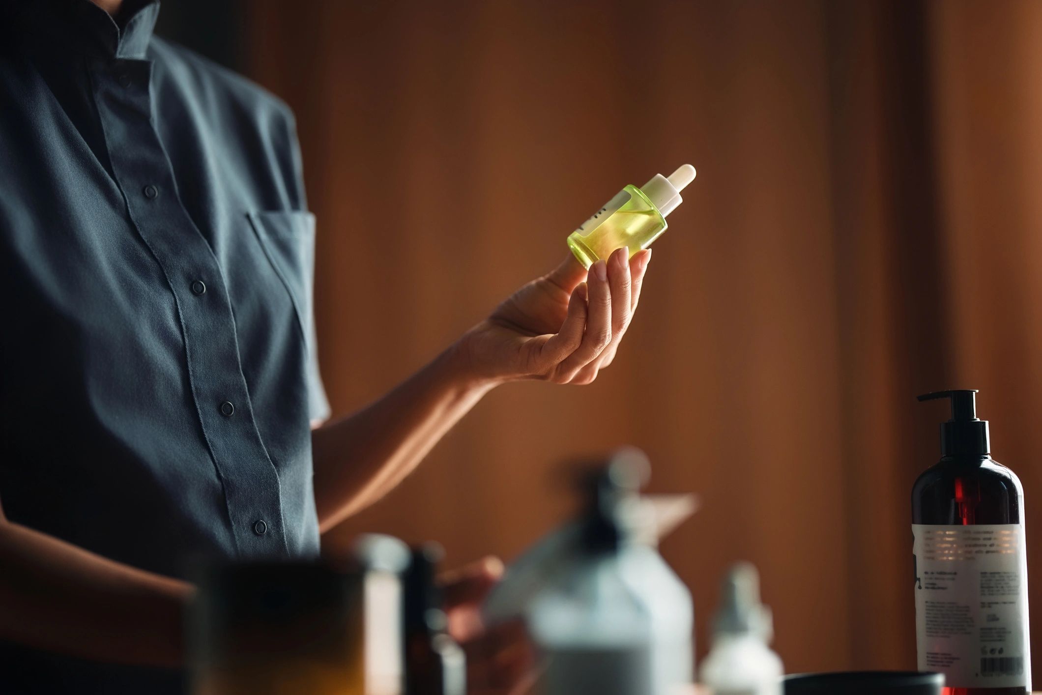 Person holding a green dropper bottle for herbal tincture use